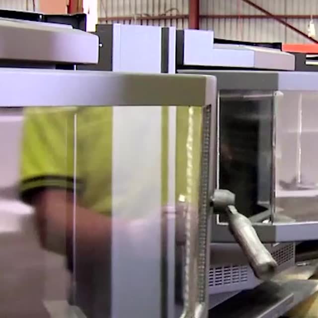 Worker assembling a heater door