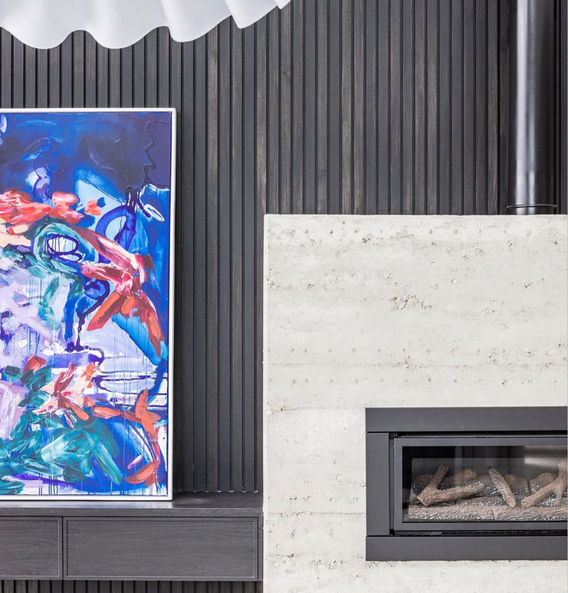 Gas fireplace styled with a dressed mantel and art above